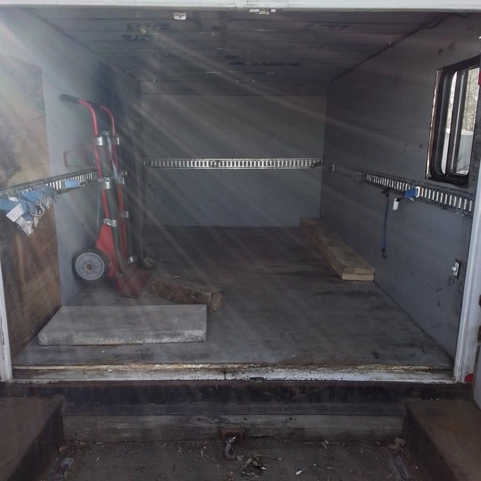 Interior cargo space inside the enclosed trailer with tie-down rails for protected loads and tools.